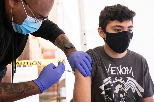 Joel, an 18-year-old student, receives a shot of COVID-19 vaccine during a vaccination drive organized by St. John's Well Child and Family at the Abraham Lincoln High School in Los Angeles, April 23rd, 2021.